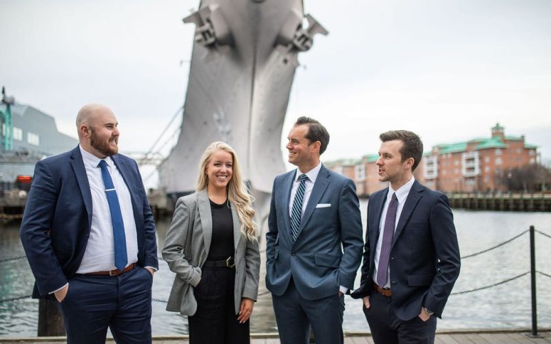 McCormick Law & Consulting team members talking on the Norfolk waterfront