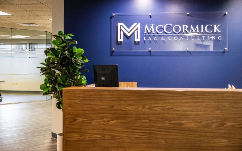 McCormick Law & Consulting reception desk and logo wall