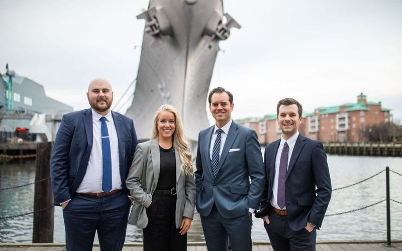 McCormick Law & Consulting team members on the Norfolk waterfront beside the battleship USS Wisconsin