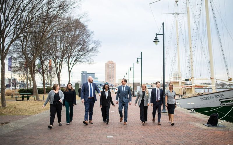 McCormick Law & Consulting team walking along the downtown Norfolk waterfront