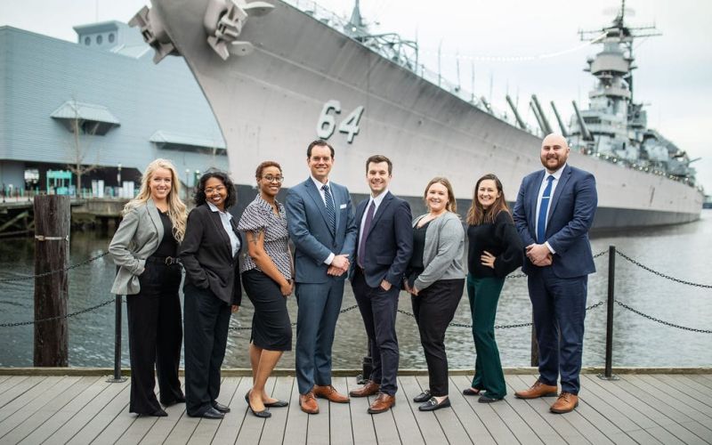 McCormick Law & Consulting team in front of the battleship USS Wisconsin in Norfolk, Virginia