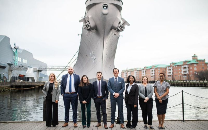 McCormick Law & Consulting team on the Norfolk waterfront near the USS Wisconsin
